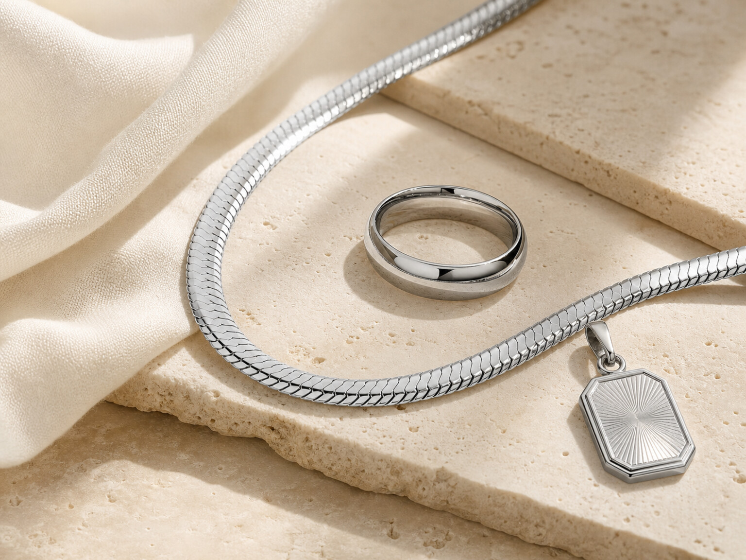 Silver jewellery on beige fabric